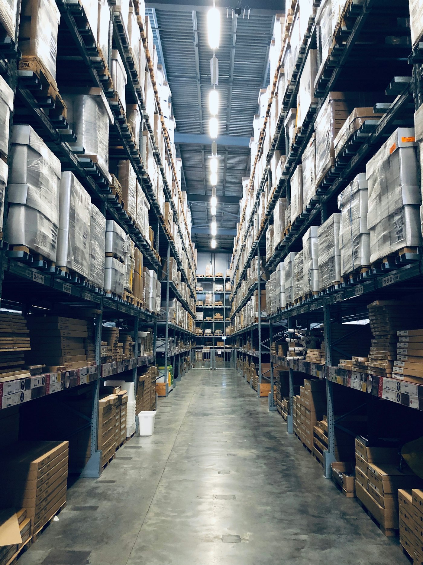 High-bay warehouse aisles stocked with commercial freight